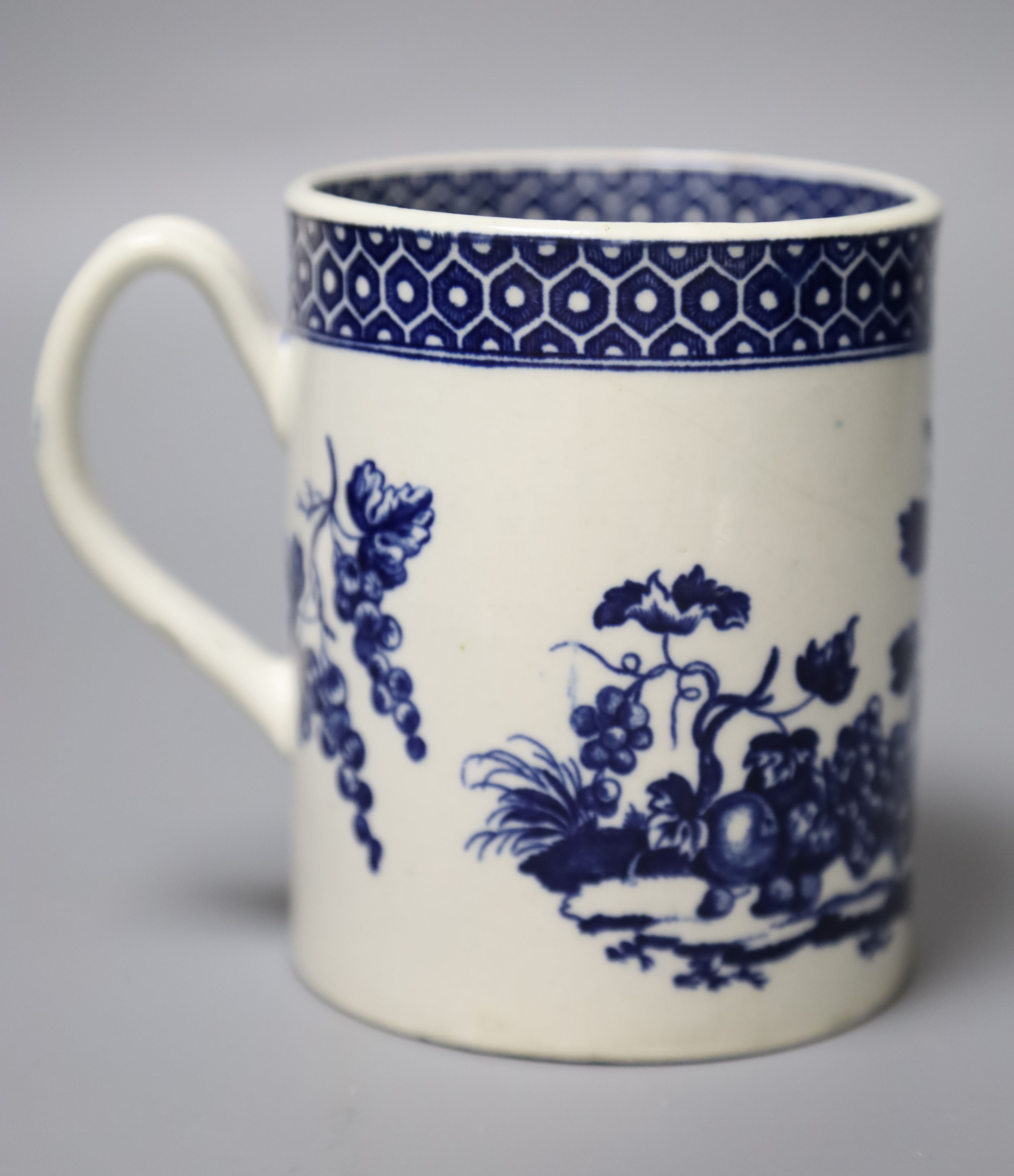 An 18th century Worcester mug printed after Hancock with Parrot Pecking Fruit pattern very rare inside and outside cell border patterns